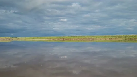 The sky with clouds is reflected in the river Video stock 195216169