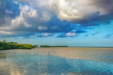 The sky with clouds reflected in the waters of the estuary. Stock Photos