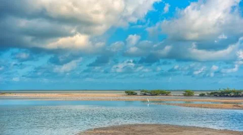 The sky with clouds reflected in the waters of the estuary. Stock Photos