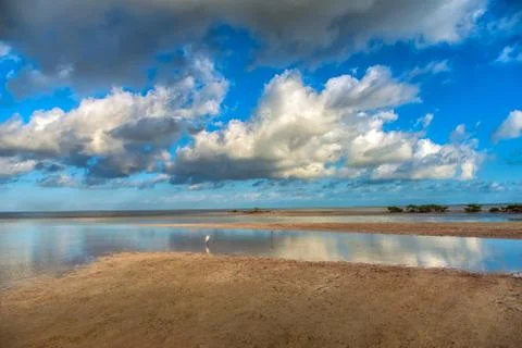 The sky with clouds reflected in the waters of the estuary. Stock Photos