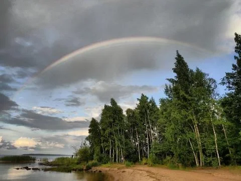 Sky, clouds, shore, rainbow Stock Photos
