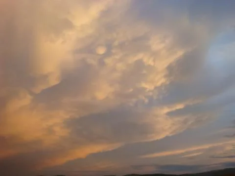 Sky with the clouds at sunset. The light of the sunset on the clouds. sky in  Stock Photos