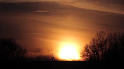 The sky with clouds at sunset - taymlaps. Sunset in the field behind the trees. Stock Footage 58391815