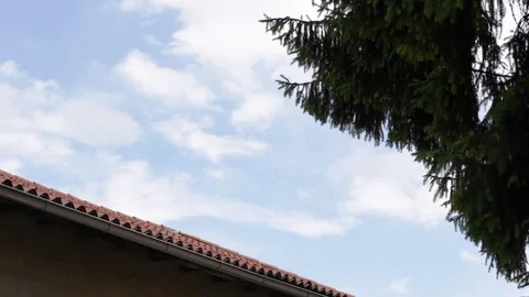 Sky with clouds of tree and roof, spring Stock Footage 117097053