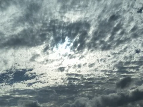 The sky is cloudy with altocumulus clouds and the sun peeking through them_05 스톡 사진