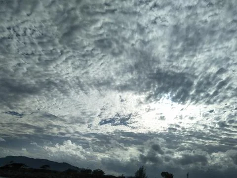 The Sky Is Cloudy With Altocumulus Clouds And The Sun Peeking Through Them_06 Stock Photos