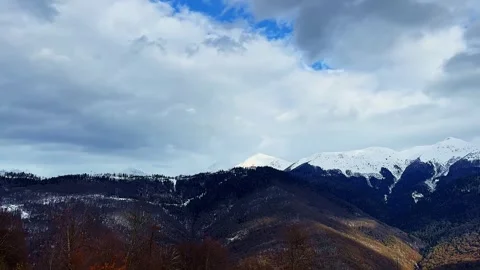 The sky is cloudy and the mountains are covered in snow Stock Footage 279057283