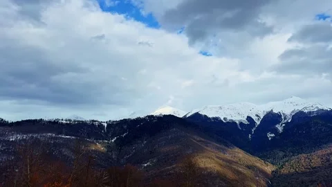 The sky is cloudy and the mountains are covered in snow Stock Footage 280003556