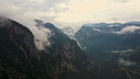 The sky is cloudy and the mountains are covered in trees Stock Footage 327911738
