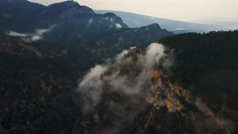 The sky is cloudy and the mountains are covered in trees Stock Footage 327914209