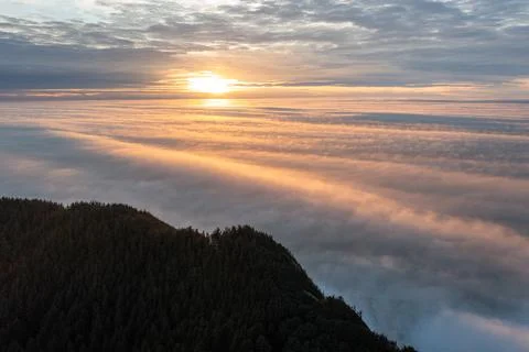 The sky is cloudy and the sun is setting Stock Photos