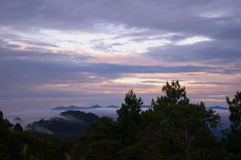 The sky is cloudy and the sun is setting Stock Photos