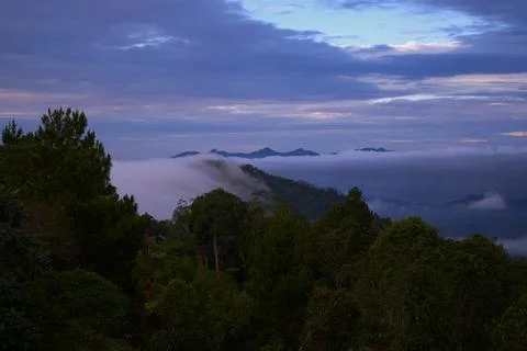 The sky is cloudy and the sun is setting Stock Photos