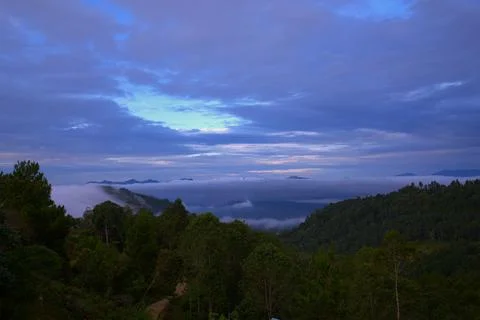 The sky is cloudy and the sun is setting Stock Photos