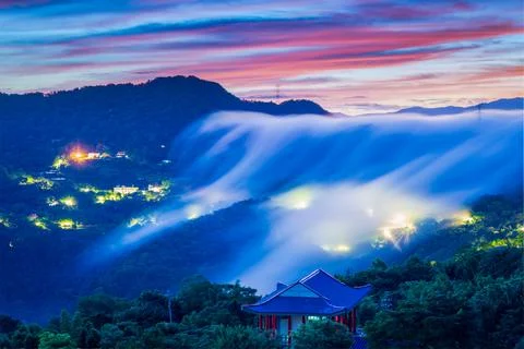 Sky colorful clouds. There is a cloud waterfall on the top of the mountain. Stock Photos
