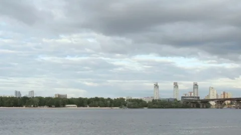 The sky is covered with clouds over a wide river Stock Footage 75476404