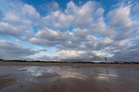 The sky is covered with dark clouds and the beach is cloudy Stock Photos