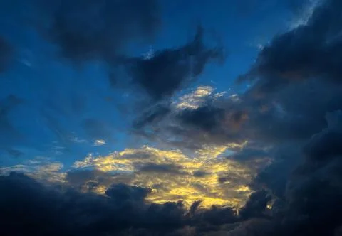 The sky is covered with dark clouds. The sky is blue on an autumn day. Stock Photos