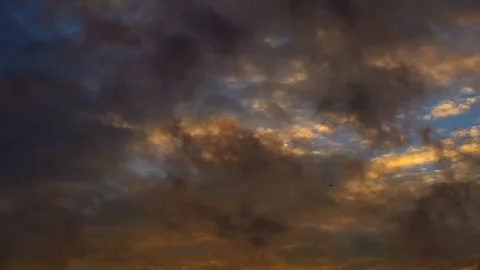 The sky is covered with dense clouds painted with the bright color of the Видео 77168850