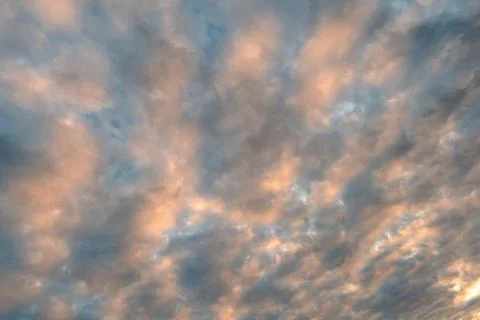The sky covered with orange clouds at sunset Фото