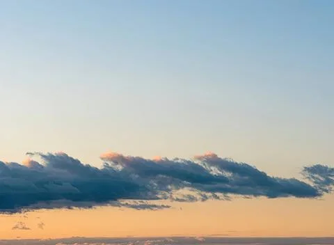Sky with dark clouds during sunset over horizon Stock Photos