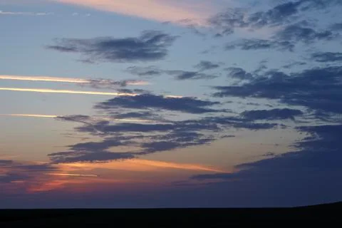 Sky - darker clouds in front of a sunset Stock Photos