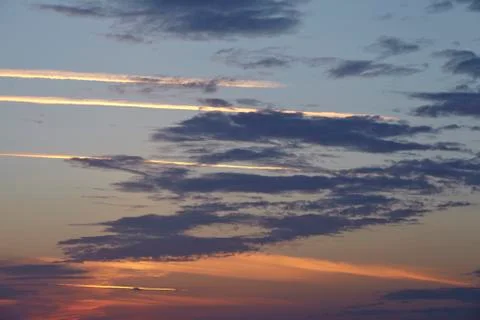 Sky - darker clouds in front of a sunset Stock Photos