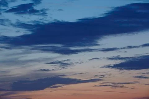 Sky - darker clouds in front of a sunset Stock Photos