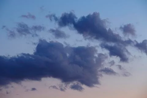 Sky - darker clouds in front of a sunset Stock Photos