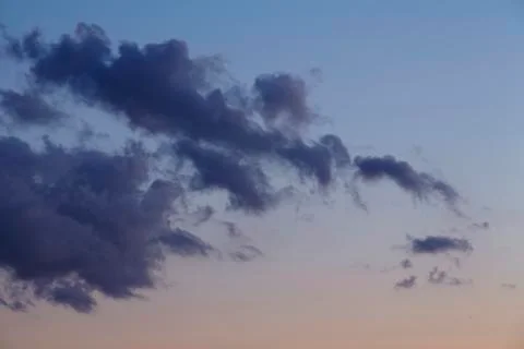 Sky - darker clouds in front of a sunset Stock Photos