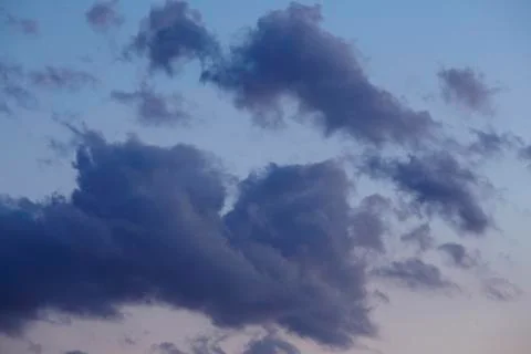 Sky - darker clouds in front of a sunset Stock Photos