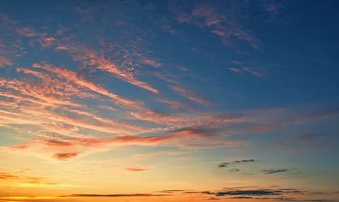 The sky before dawn, orange clouds on the background of the blue sky. Stock Photos