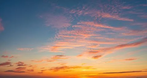 The sky before dawn, orange clouds on the background of the blue sky. Stock Photos
