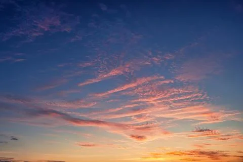 The sky before dawn, orange clouds on the background of the blue sky. Stock Photos