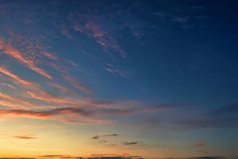 The sky before dawn, orange clouds on the background of the blue sky. Stock Photos