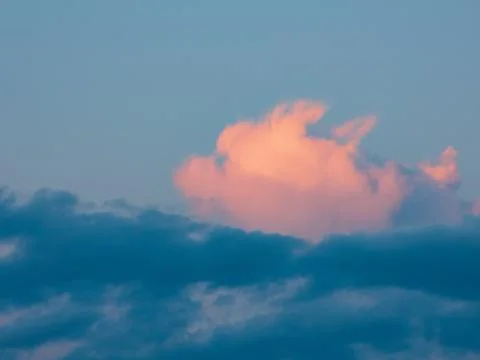 The sky at dawn. Pink upper clouds are colored by the rising sun Stock Photos