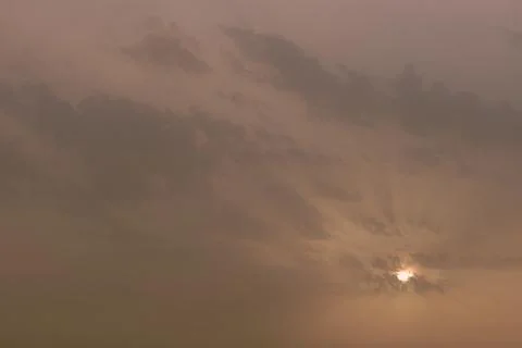 A sky, with diffused sun, clouds, colourful, Stock Photos