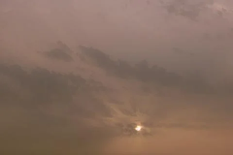 A sky, with diffused sun, clouds, colourful, Stock Photos