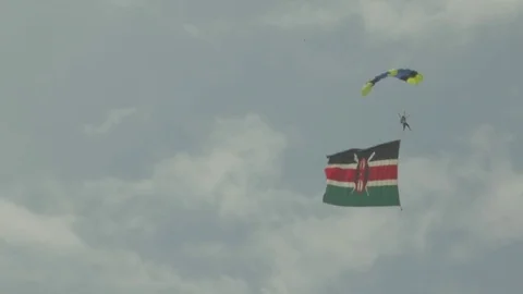 Sky diver soars through the air with a Kenyan flag. Stock Footage 82328152