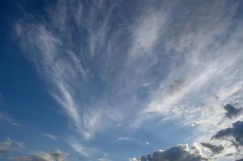 Sky with Diverse Cloud Types: Wispy Cirrus High Up and Dense Cumulus Below Stock Photos