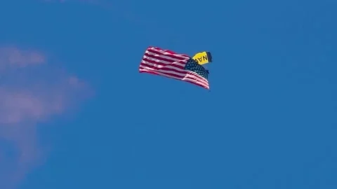 SKY DIVING PARACHUTE JUMPER GLIDING ACROSS THE SKY Stock Footage 345276759