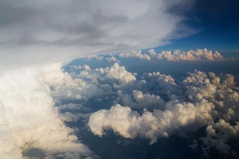 Sky with dramatic beautiful white fluffy clouds viewed from airplane, blue .. Stock Photos