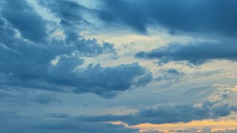 Sky with dramatic dark blue clouds at sunset Stock Photos