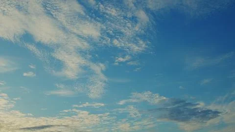 The sky at dusk is adorned with clouds, showcasing vibrant blue shades and natur Stock Photos
