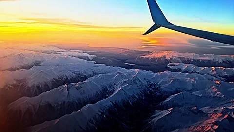 The sky is filled with clouds and the mountains are covered in snow Stock-Footage 277258174