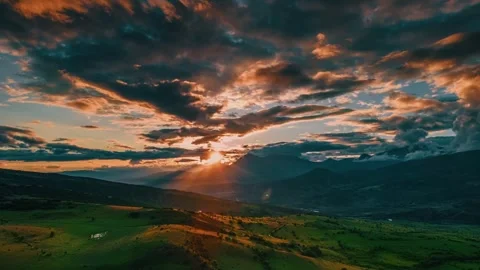 The sky is filled with clouds and the sun is setting in the distance time lapse Stock Footage 331359753