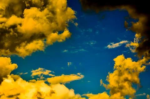 The sky is filled with clouds and the sun is shining through them Stock Photos