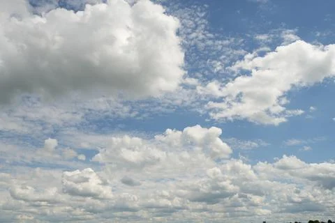 The sky is filled with clouds and the sun is shining through them Stock Photos