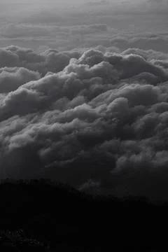 The sky is filled with dark clouds, creating a moody and ominous atmosphere 스톡 사진