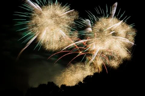 The sky is filled with feathers after an explosion of fireworks. Stock Photos